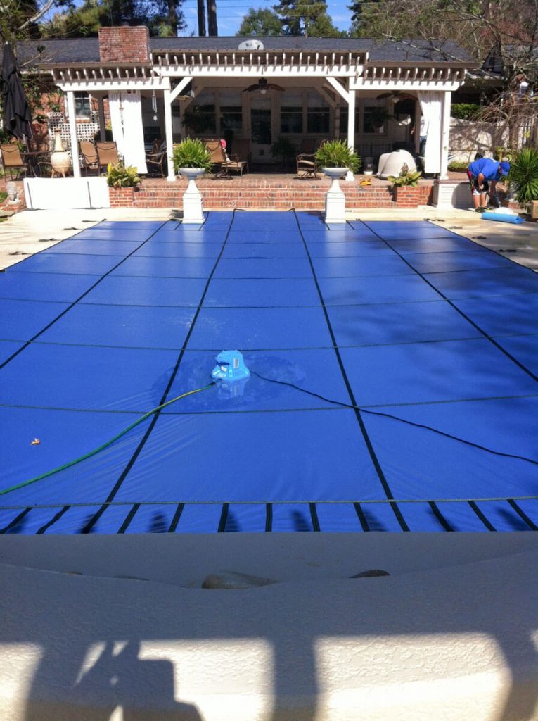 Tara's pool cover solid with automatic pump blue