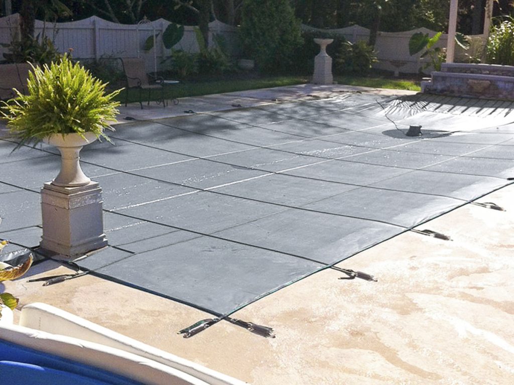 Tara's pool cover solid with automatic pump gray