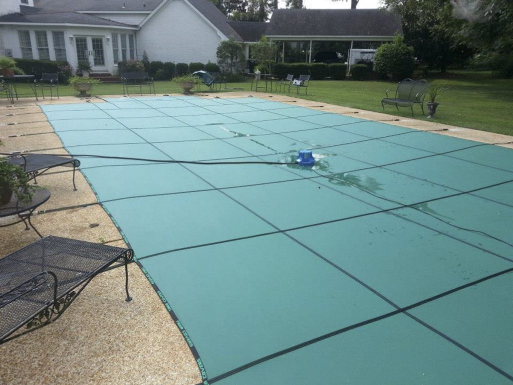 Tara's pool cover solid with automatic pump green